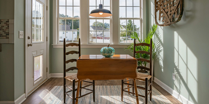 Photo of a sage green kitchen from the inside.