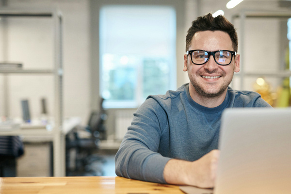 Photo of a man working at his laptop