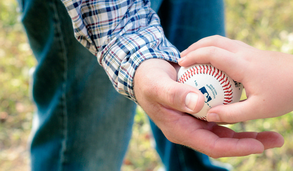 Photo of a person holding a baseball